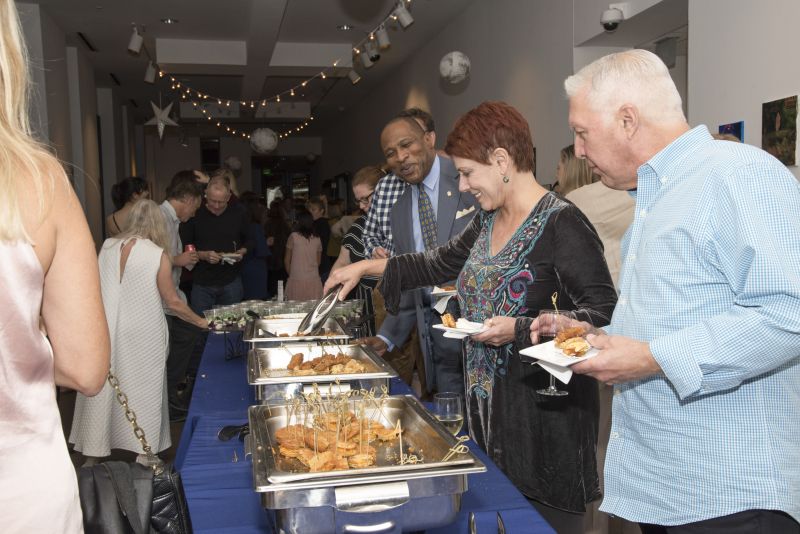 Guests snack on fried green tomatoes, fried shrimp, and chicken and waffles