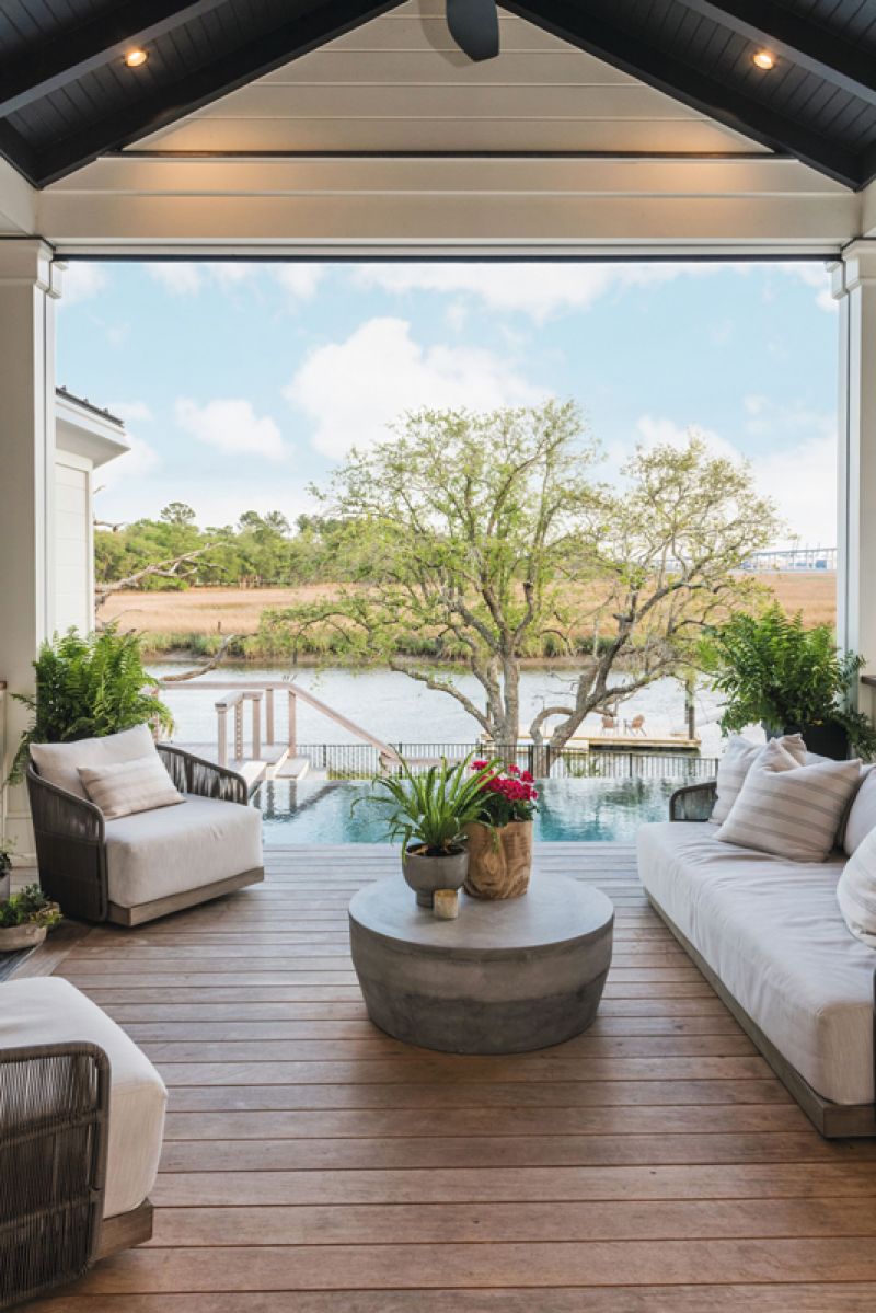 Overlooking the pool and Ralston Creek, the comfortably appointed, covered back porch is a prime relaxation spot during all seasons, complete with a wood-burning fireplace, retractable screens, and a ceiling fan.