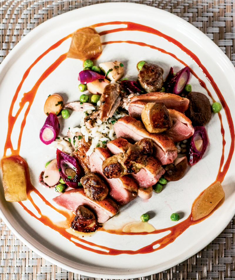 ART OF THE PLATE: Buttery duck breast is seared on an iron skillet and served with Nostrale rice, foie gras, vegetables, and Bradford watermelon molasses.