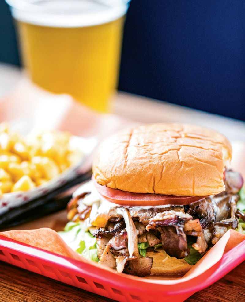 BETTER THAN PHILLY: A riff on the Philly cheesesteak, Rodney’s ribeye sandwich is piled high with thinly sliced meat, melted cheese, and caramelized onions.