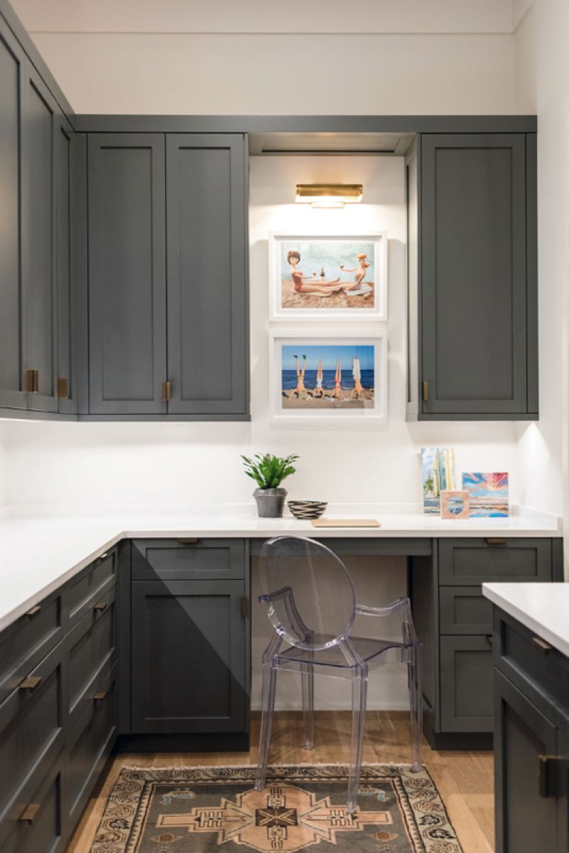 In the butler’s pantry, where small appliances are tucked away, colorful artworks spiff up the utilitarian room.