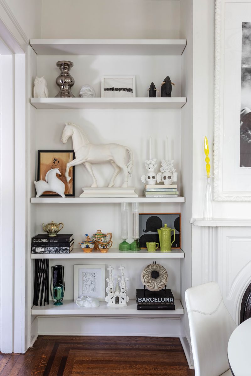 The dining room bookshelves display art, ceramics, and memorabilia from Mexico and other travels.