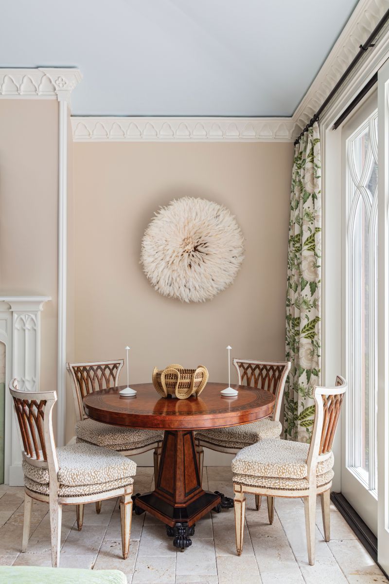 ...vintage Baker Furniture game table with antique white and gold Italian side chairs flank the fireplace.