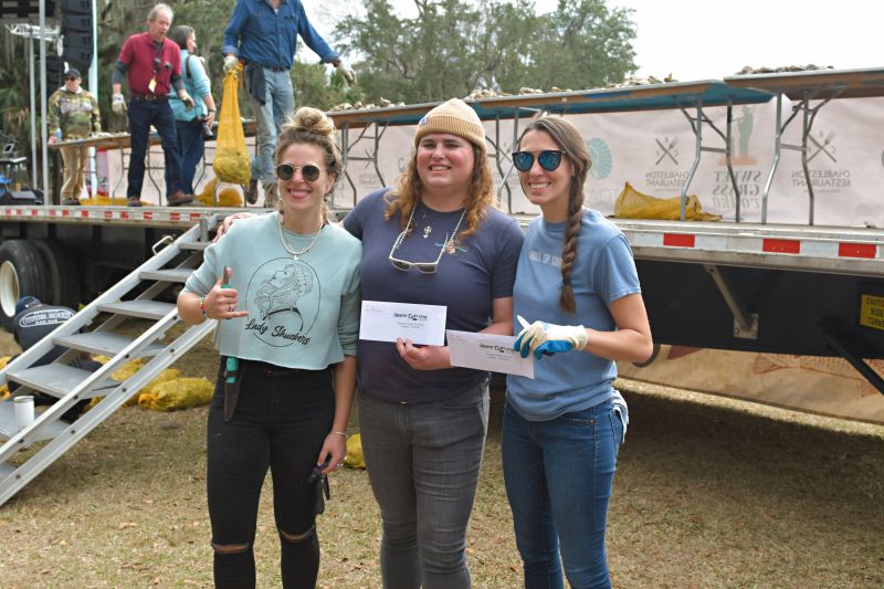 Oyster shuckers Libby Davis, Isabella Macbeth, and Sarah Boyle celebrate their victories.