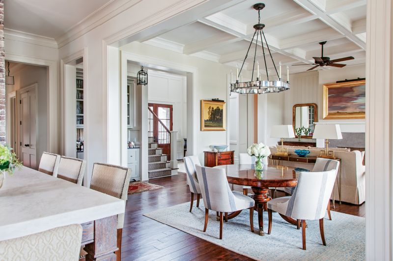 in the mix: Accent walls of brick and butted board help to set a welcoming, laid-back tone, while gilt-framed artwork and fixtures from Circa and Urban Electric add touches of elegance.