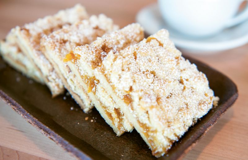 Raising the Bar: The sticky fruit jam acts as a binding agent to hold the dough together. Before serving, dust the three-inch squares with powdered sugar.