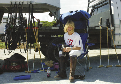 Player and Hyde Park Farm &amp; Polo Club owner Amy Vann Flowers (top, right) rests in a shade chair during the annual beach polo match on Kiawah Island.